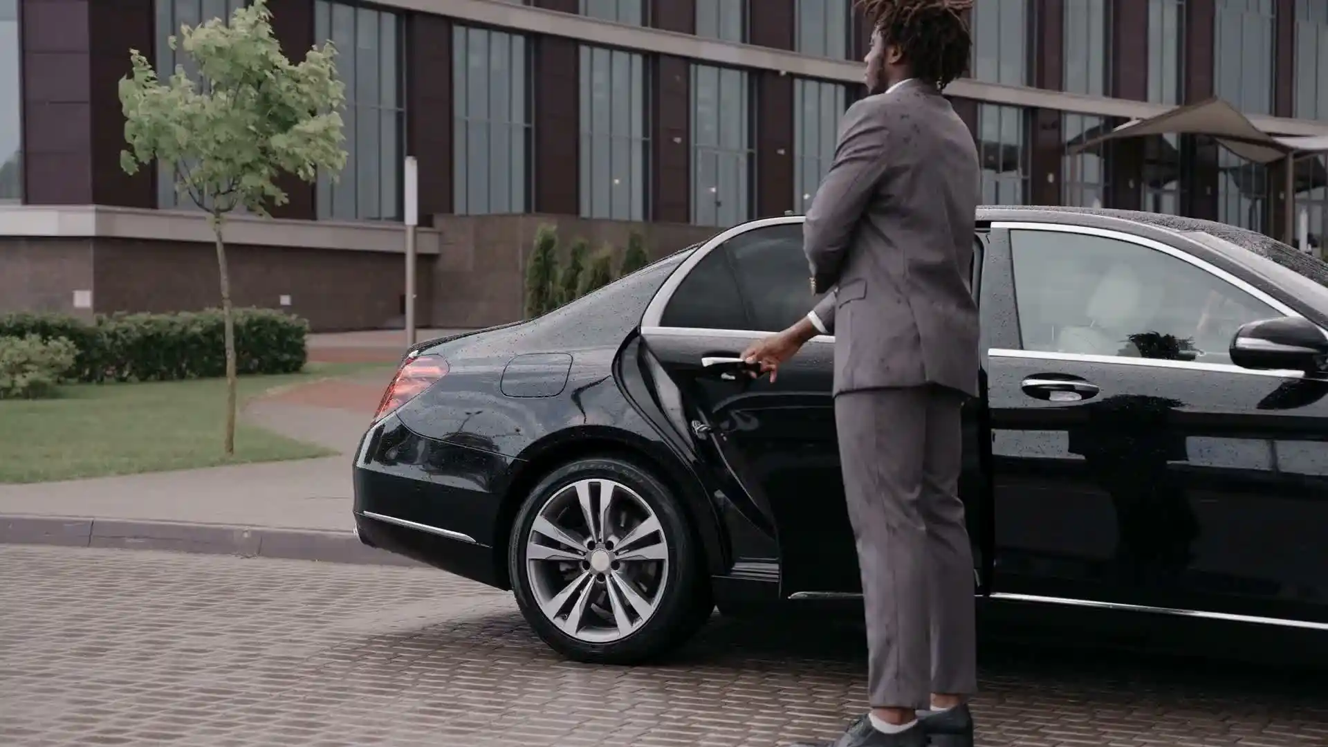 A RielVIP chauffeur greeting a client curbside